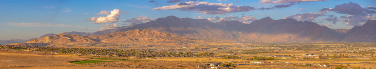 Naklejka premium Homes and majestic mountain under sky with clouds