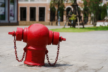 Red water dispenser fire hydrant on footpath.