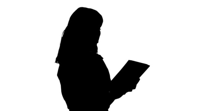 Silhouette Woman in red t-shirt using tablet.