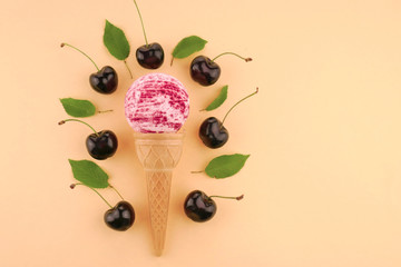 Cherry Bath Bomb.Pink striped bombs for a bath in a waffle cup and ripe sweet cherry berries on light  beige background.Organic cosmetics with  cherry extract
