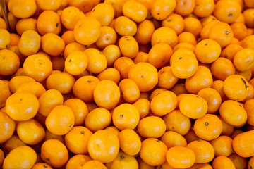 A heap of mandarins, tangerines or clementines at the farmers market