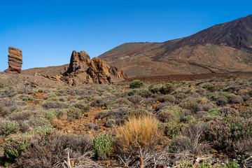The lava fields of Las Canadas caldera of Teide volcano and rock formations - Roques de Garcia. Tenerife. Canary Islands. Spain.