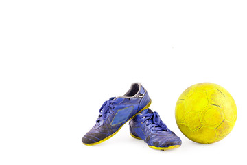 old vintage damaged futsal sports shoes and ragged yellow ball on white background football  object...