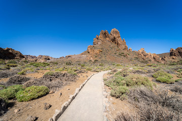 The lava fields of Las Canadas caldera of Teide volcano and rock formations - Roques de Garcia. Tenerife. Canary Islands. Spain.