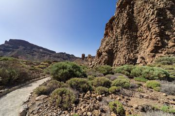 The lava fields of Las Canadas caldera of Teide volcano and rock formations - Roques de Garcia. Tenerife. Canary Islands. Spain.