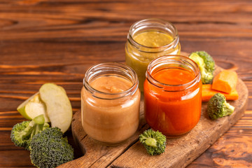 Variation pureed baby food in glass jars with ingredients