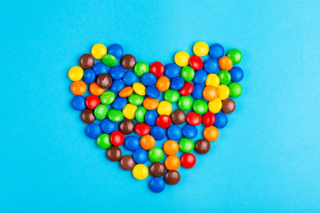 A lot of glazed chocolate colored candies shaped into heart