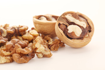A pile of peeled walnuts at white background