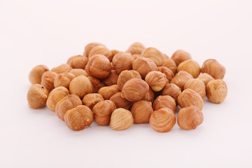 A pile of hazelnuts at white background