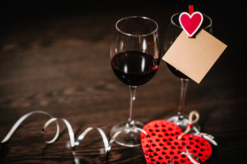 Blank, craft paper, red heart, wine on brown wooden background with space. Place for text. concept Women's Day, eighth of March. Wedding, jubilee. Love.