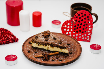 A romantic dinner with candles for Valentine's Day. Cake with coffee. Decorated red hearts on a white wooden background. Card with romantic composition love. space for text. happy holidays.