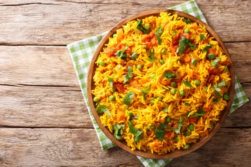 Photo sur Plexiglas Plats de repas Indian food Tawa Pulao rice with vegetables and spices close-up. horizontal top view