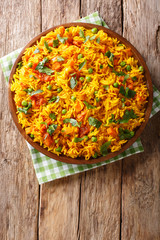 Indian food Tawa Pulao rice with vegetables and spices close-up. Vertical top view