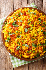 Tawa Pulao is a popular Mumbai street food of rice with vegetables and spices close-up. Vertical top view