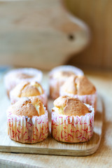 Cheese muffins or cupcakes on light wooden texture. Daylight. Selective focus.