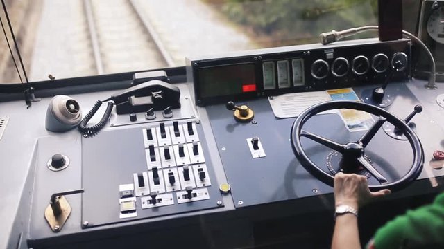 a narrow gauge tourist train driver controls the vehicle 