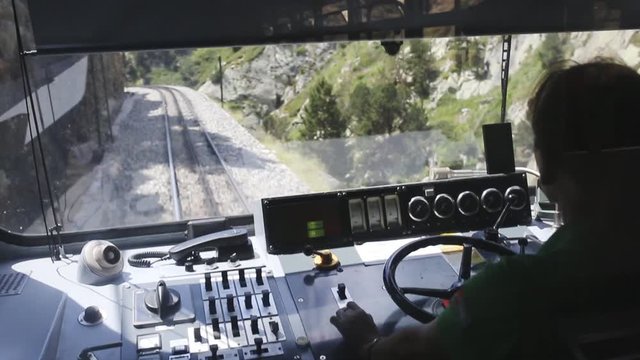 a narrow gauge tourist train driver controls the vehicle 