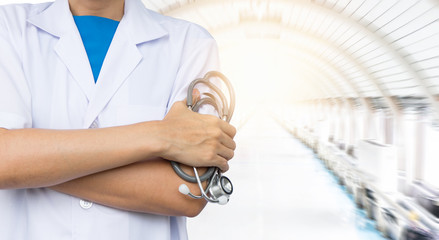 Doctor with stethoscope on blurred hospital background.