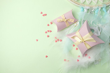 Gift boxes with ribbon on green pastel background with copy space. Minimal cincept of spring holiday. Top view, spring valentine romantic background