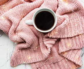 Cup of coffe, sweater and garland
