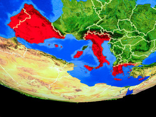 Southern Europe from space on model of planet Earth with country borders.