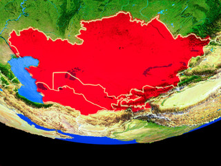 Central Asia from space on model of planet Earth with country borders.
