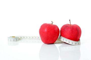 Diet concept measuring tape with red apples isolated on white Background ,Fruit diet weight loss.