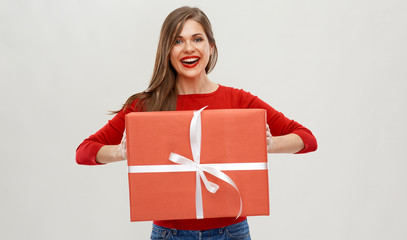 portrait of woman in red holding big gift box.