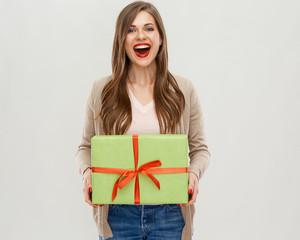 Happy woman holding green gift box.