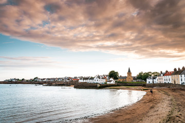 Fototapeta premium Vacation in Scotland with picturesque sunset in the small fishing village Anstruther on the Scottish east coast, not far from St. Andrews, the small fishing boats in the marina are perfect for relaxin