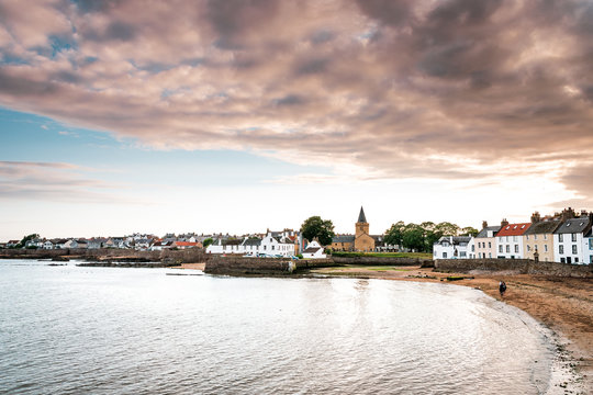 Vacation in Scotland with picturesque sunset in the small fishing village Anstruther on the Scottish east coast, not far from St. Andrews, the small fishing boats in the marina are perfect for relaxin