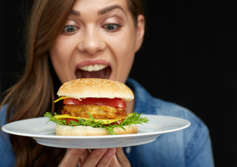 face portrait of smiling woman eating burger