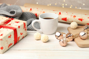 Packing Christmas presents with cup hot tea