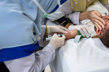 Doctor taking blood to examine the sickness for child.