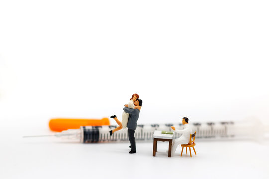 Miniature people: Lover meet doctor with syringe. Health care and business concept.