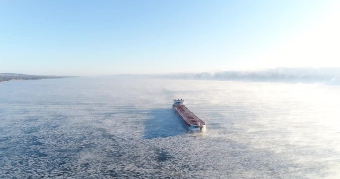 Cargo Ship Cruising on Frozen Lake Superior - Sea Smoke