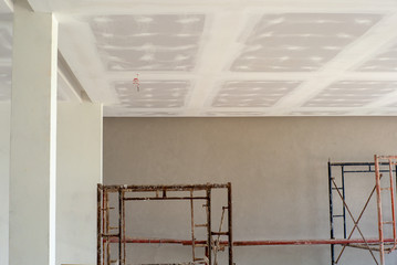 Perspective inside the house under construction. Plastered white cement applied on the ceiling board