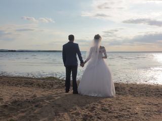 Wedding, the couple looks to the future. Summer on the beach