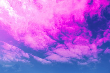 Pink clouds on blue sky background