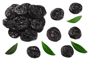 Dried plums - prunes with green leaves isolated on white background. top view