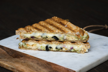 chicken panini with olives on board