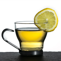 Lemon rea in a glass cup against a white background (square)