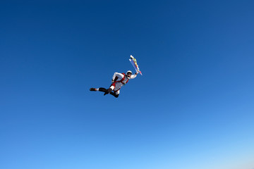 Naklejka na ściany i meble Skydiver is in the blue sky.