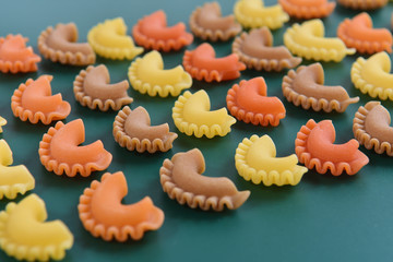 Pasta creste di gallo on green background