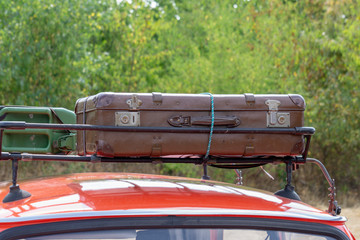 Old suitcases tied to the roof of the car