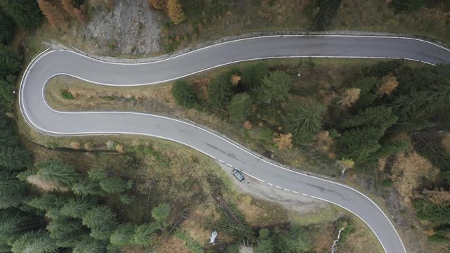 Aerial of a winding road in the Italian Dolomites.