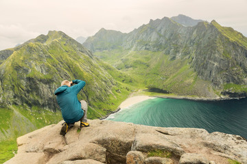 Photographer taking pictures of the amazing Kvalvika beach at the Lofoten Islands, Norway