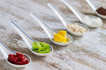 POrcelain spoons with food ingredients