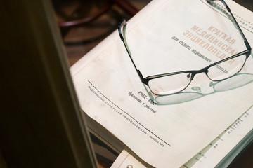 glasses on vintage russian book (medical encyclopedia)