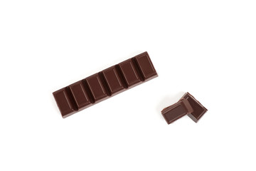 Close-up pieces of chocolate bar with filling isolated on white background.